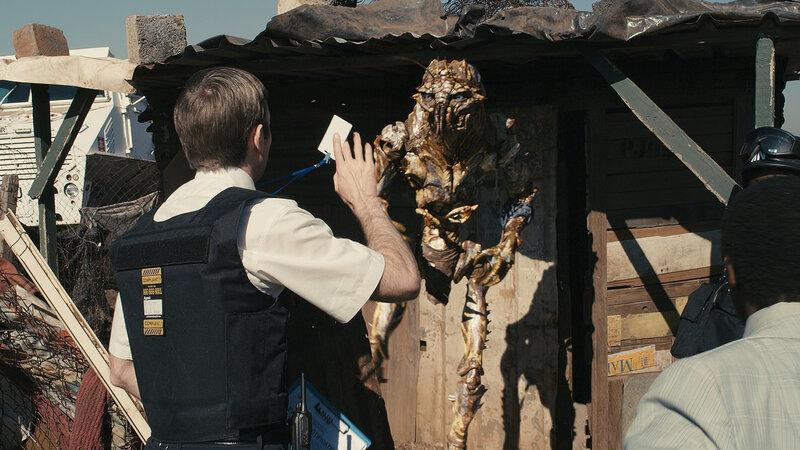 Alien creature in a shanty town
