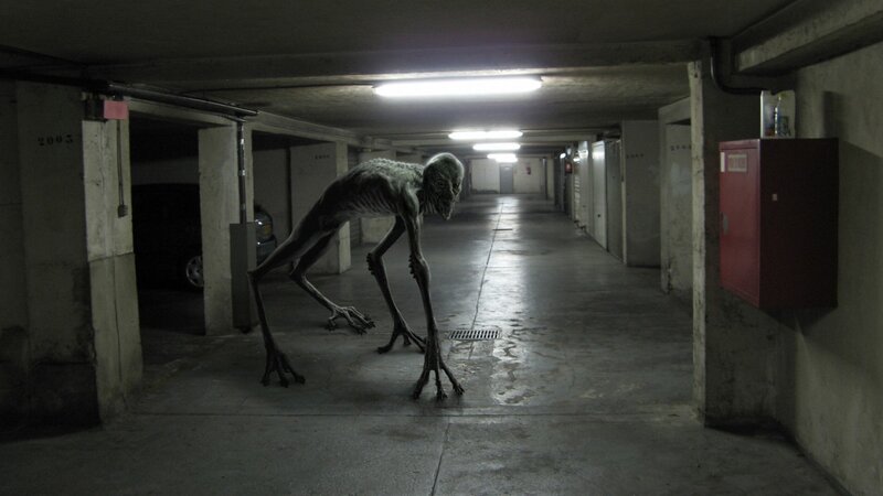 Alien Creature in Garage — Gray, Dark, Tense
