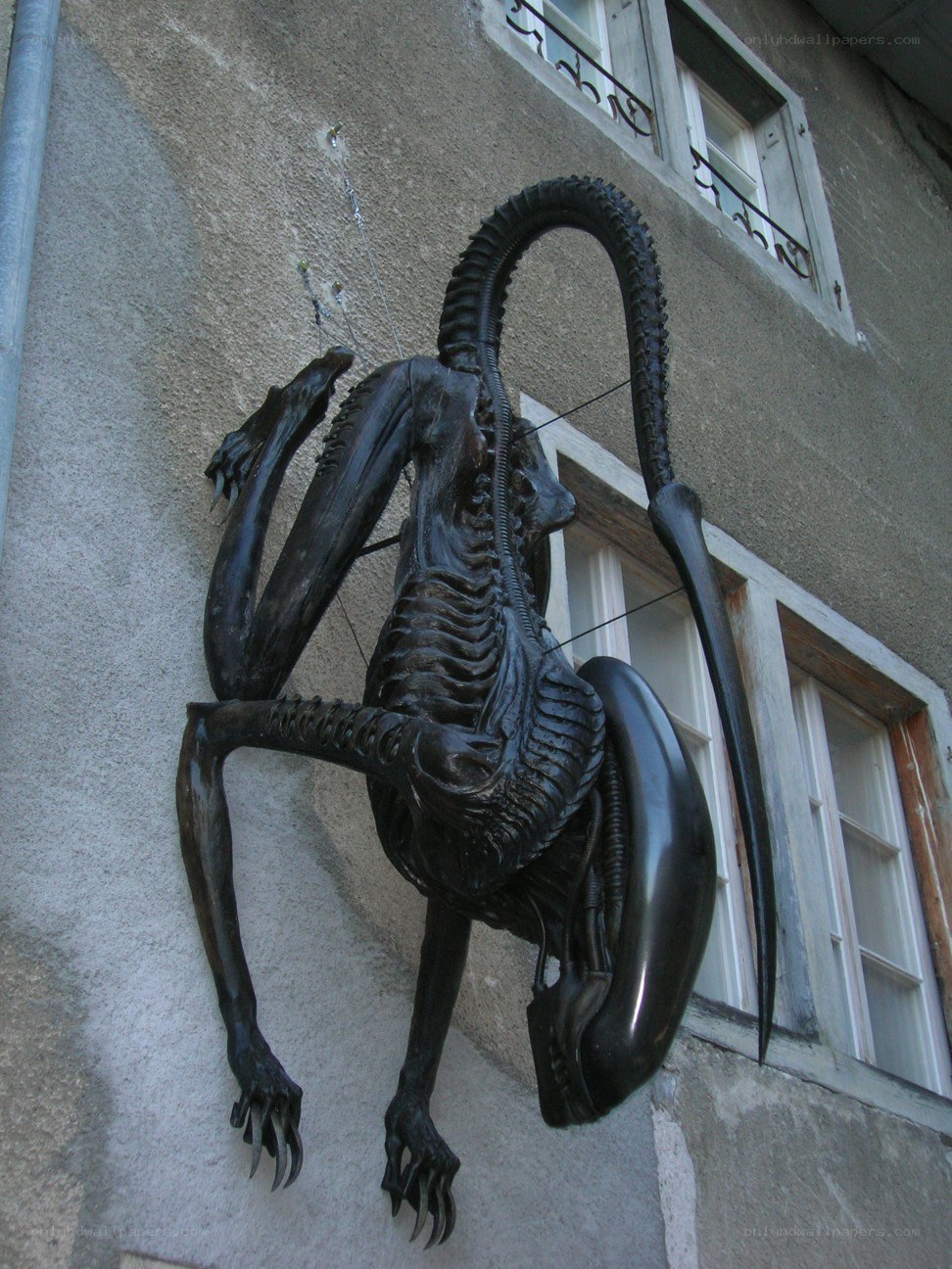 Alien creature sculpture on building