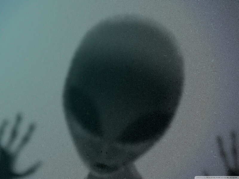 Alien Figure Behind Glass — Gray