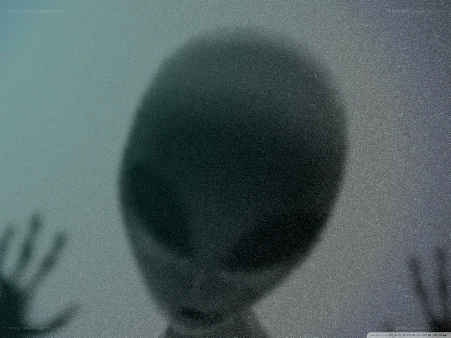 alien figure behind glass