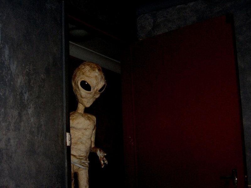 Alien Figure in Doorway