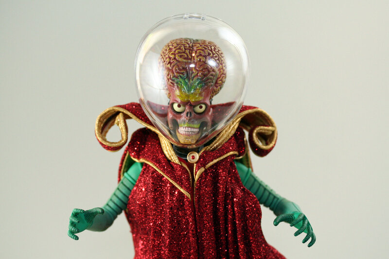 Alien Figure in Red Cloak