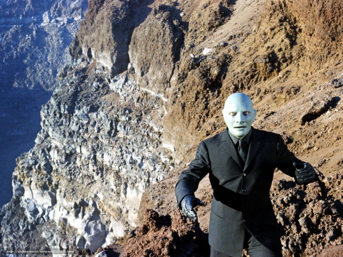 alien in black suit on cliff