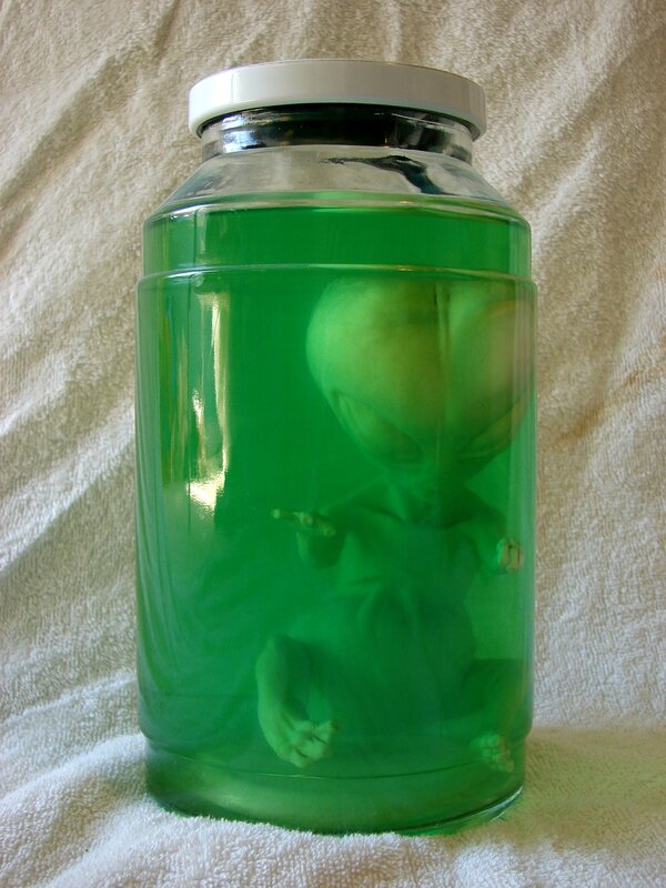 alien in green liquid jar
