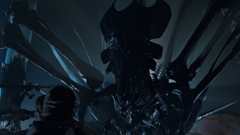 Alien queen in dark chamber