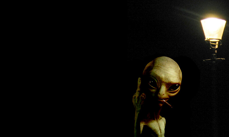 alien smoking under streetlight