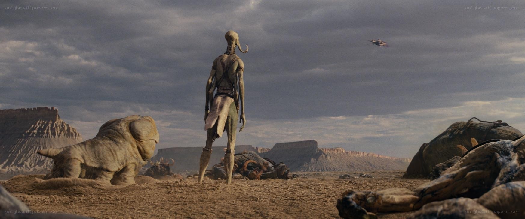 alien stands in desert wasteland