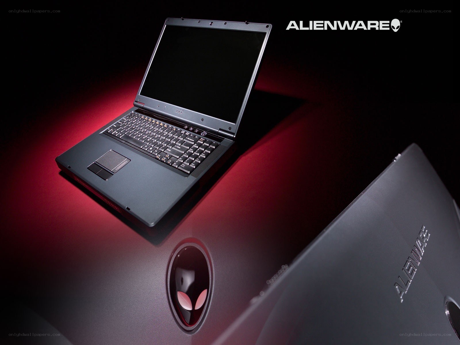 Alienware laptop on red surface