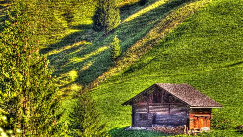 Alpine cabin on a sunny hillside