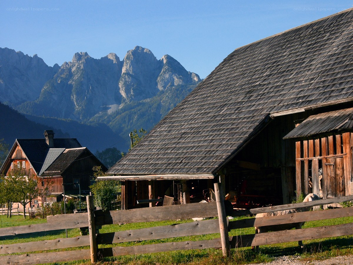 Alpine farm with mountain backdrop