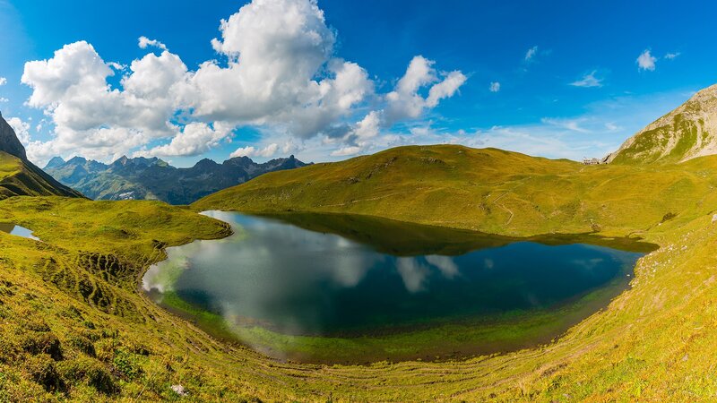 Alpine Lake in Valley — Blue, Serene, Afternoon, Photograph, Mountains, Clouds, Grass
