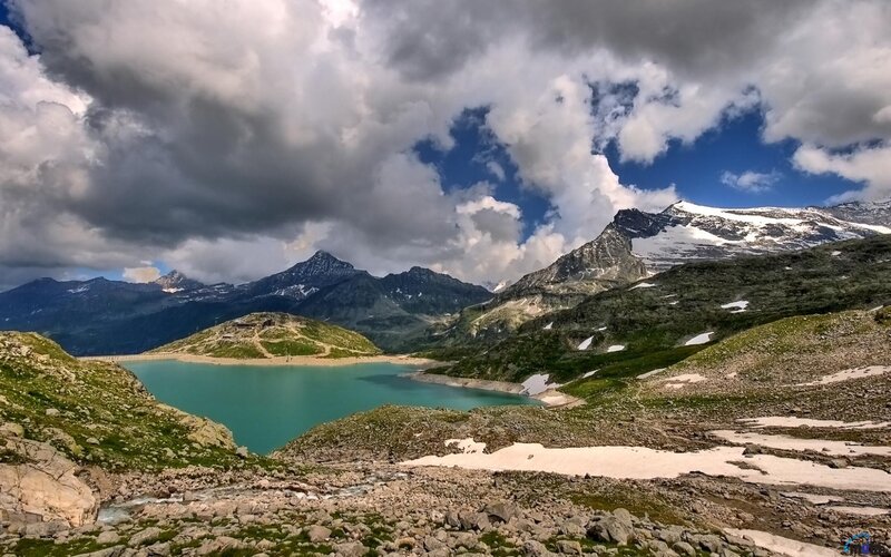 alpine lake with snow-capped mountains