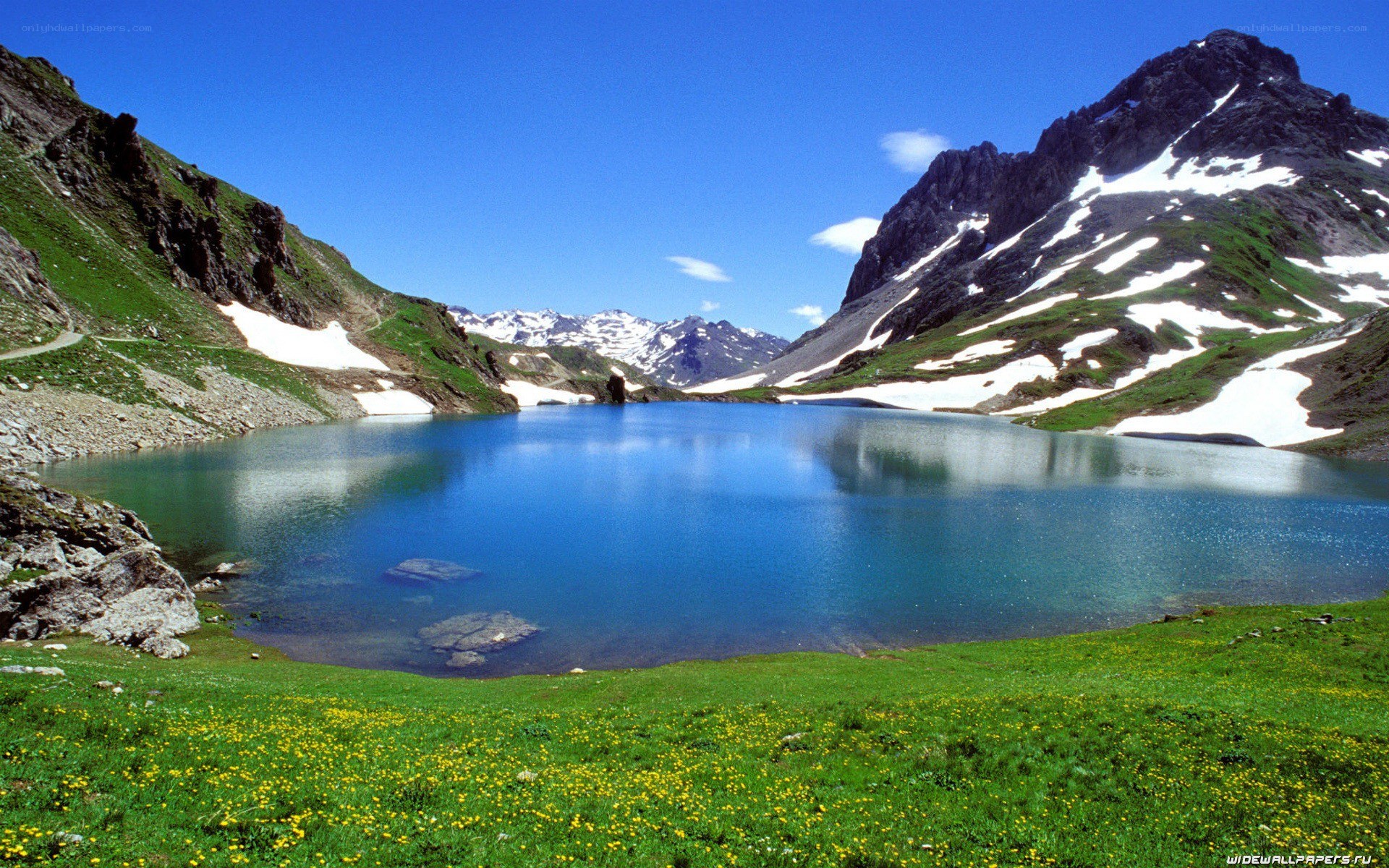 alpine lake with snow-capped mountains