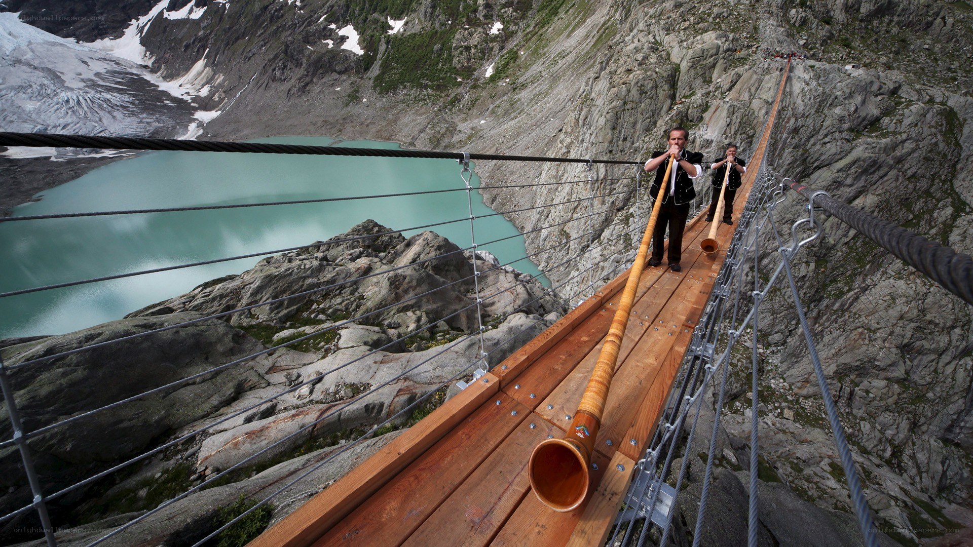 Alpine musicians on a suspension bridge