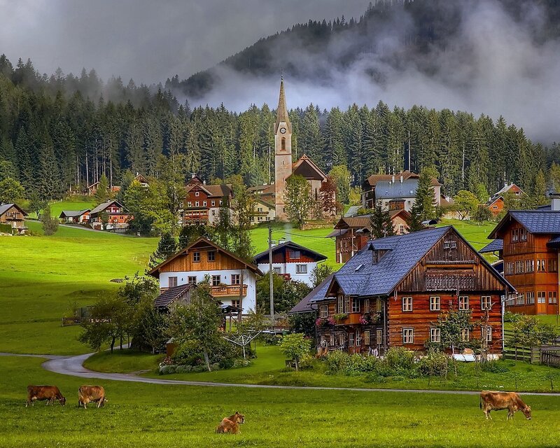 Alpine village in misty mountains