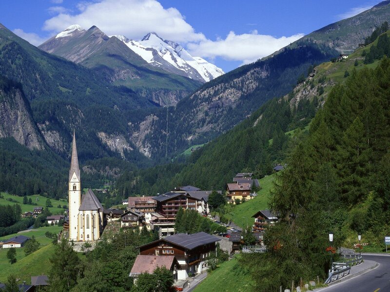 Alpine village with church and mountains