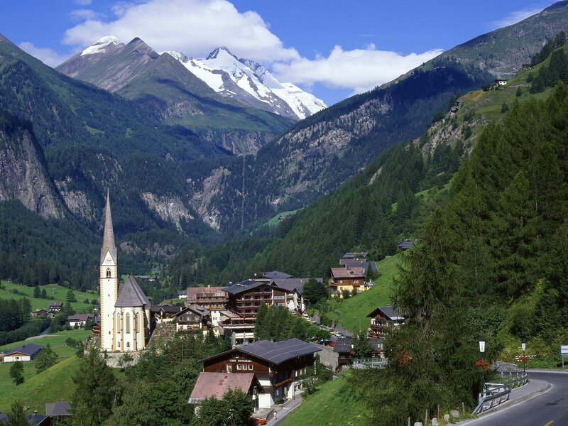 alpine village with church and mountains
