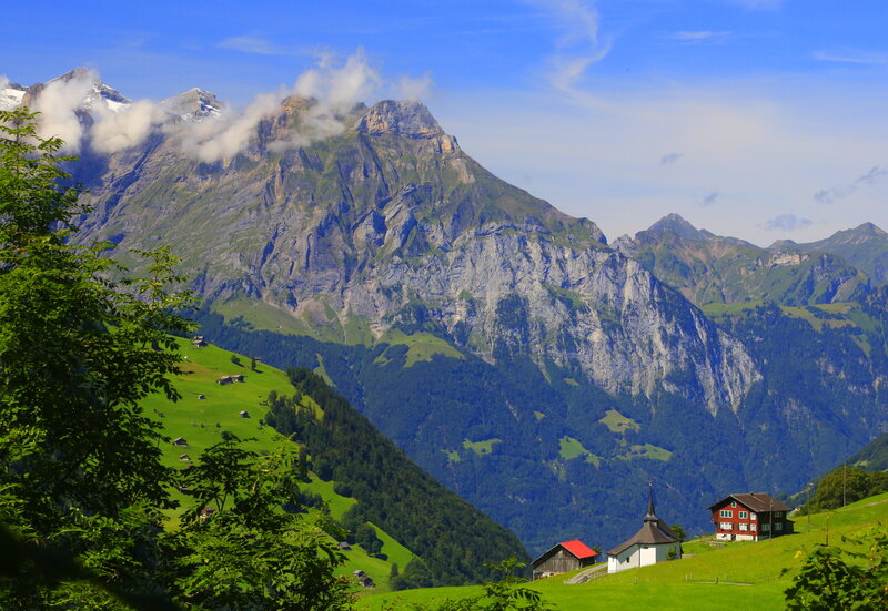 Alpine Village with Mountains — Green, Serene, Afternoon