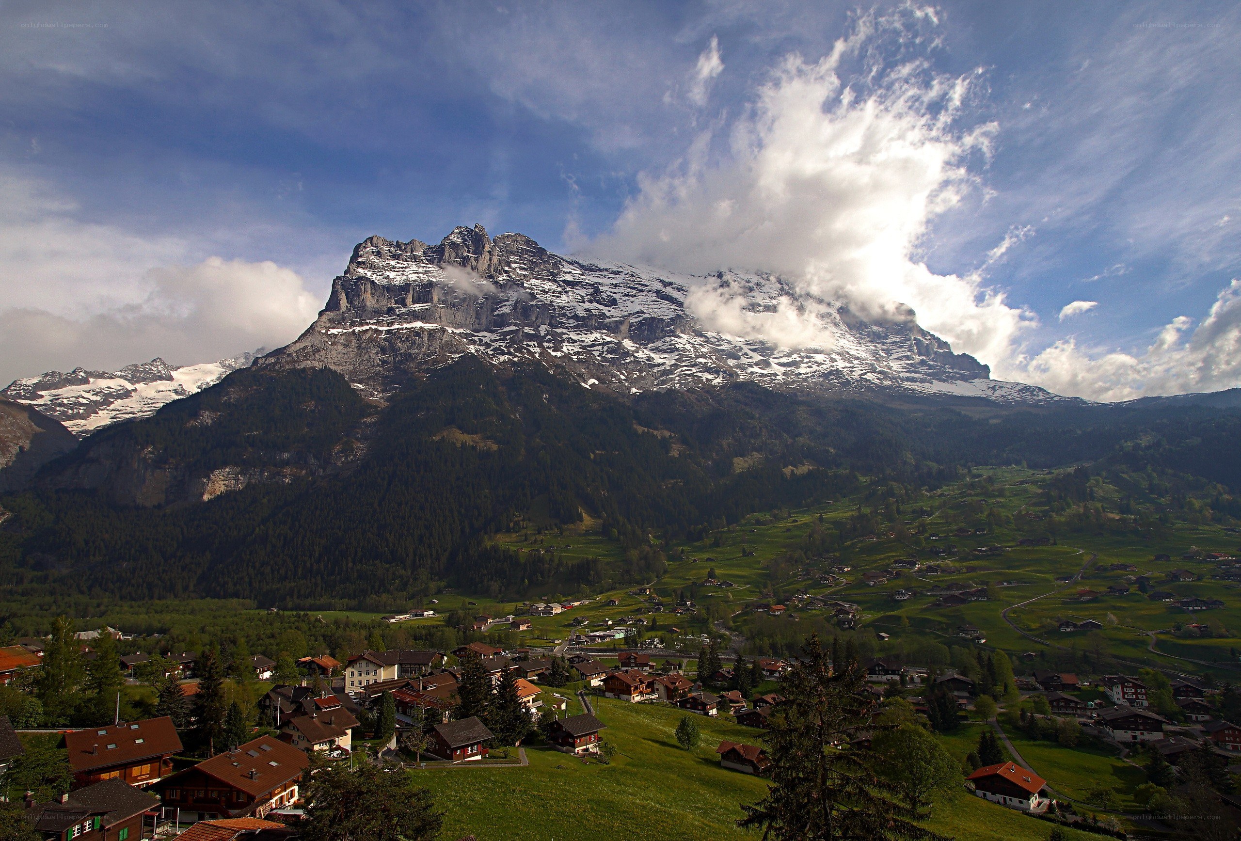 Alpine village with snow-capped mountain
