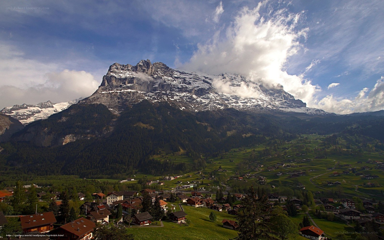 Alpine village with snow-capped mountain