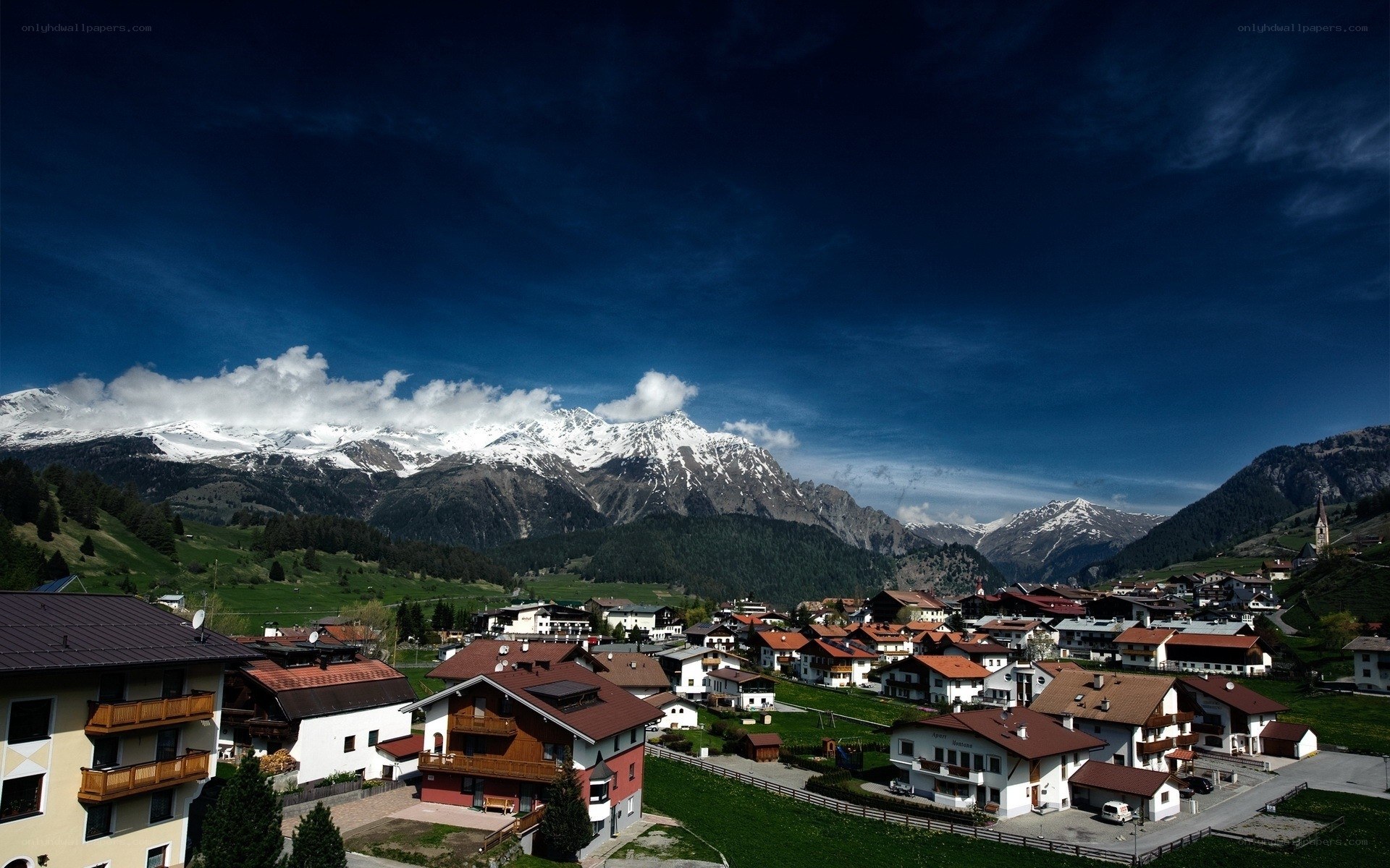Alpine village with snow-capped mountains