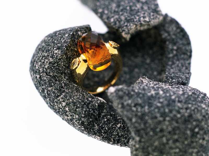 amber gemstone ring on stone