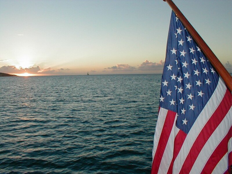 American flag at sunset on the ocean