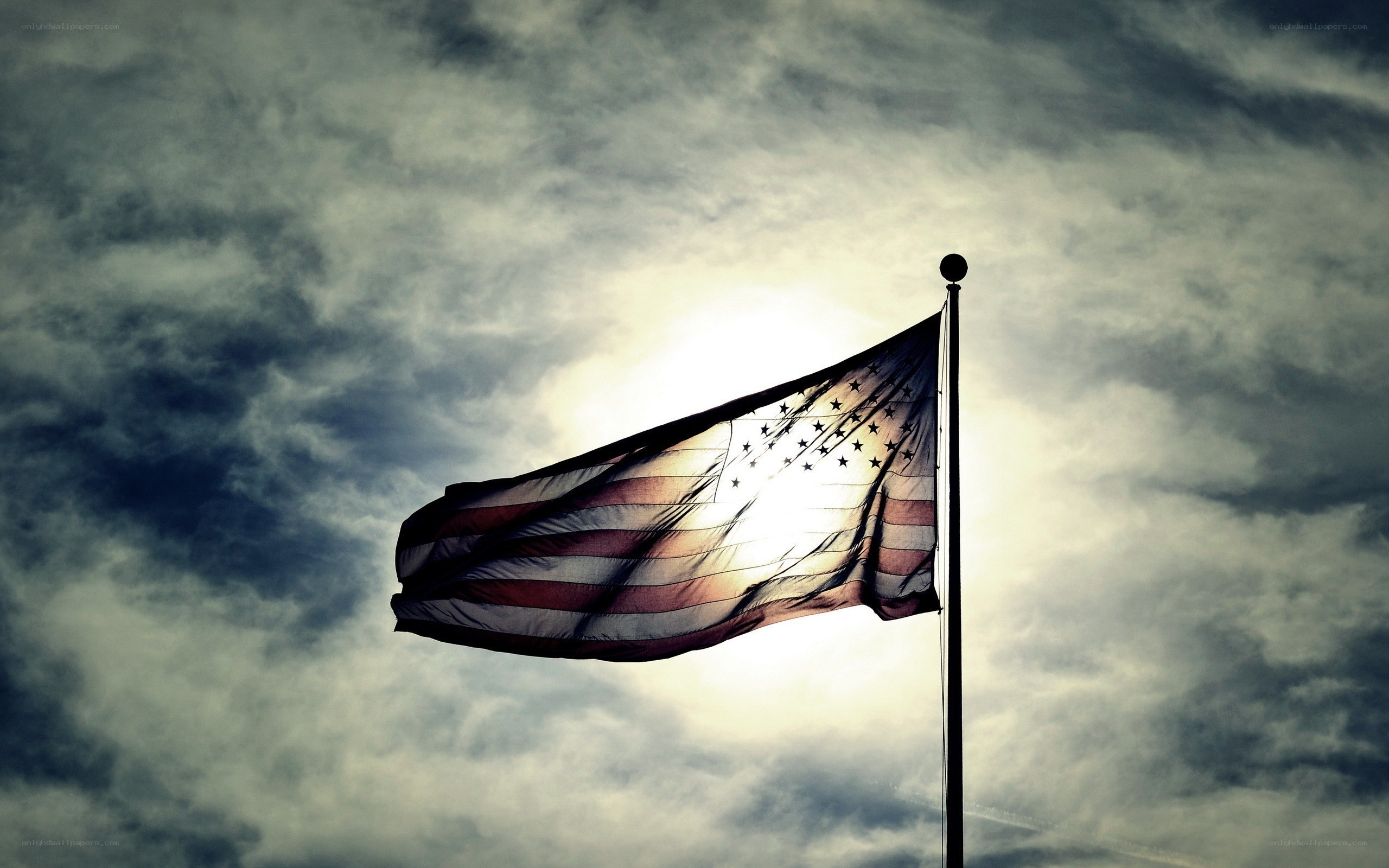 American flag in cloudy sky