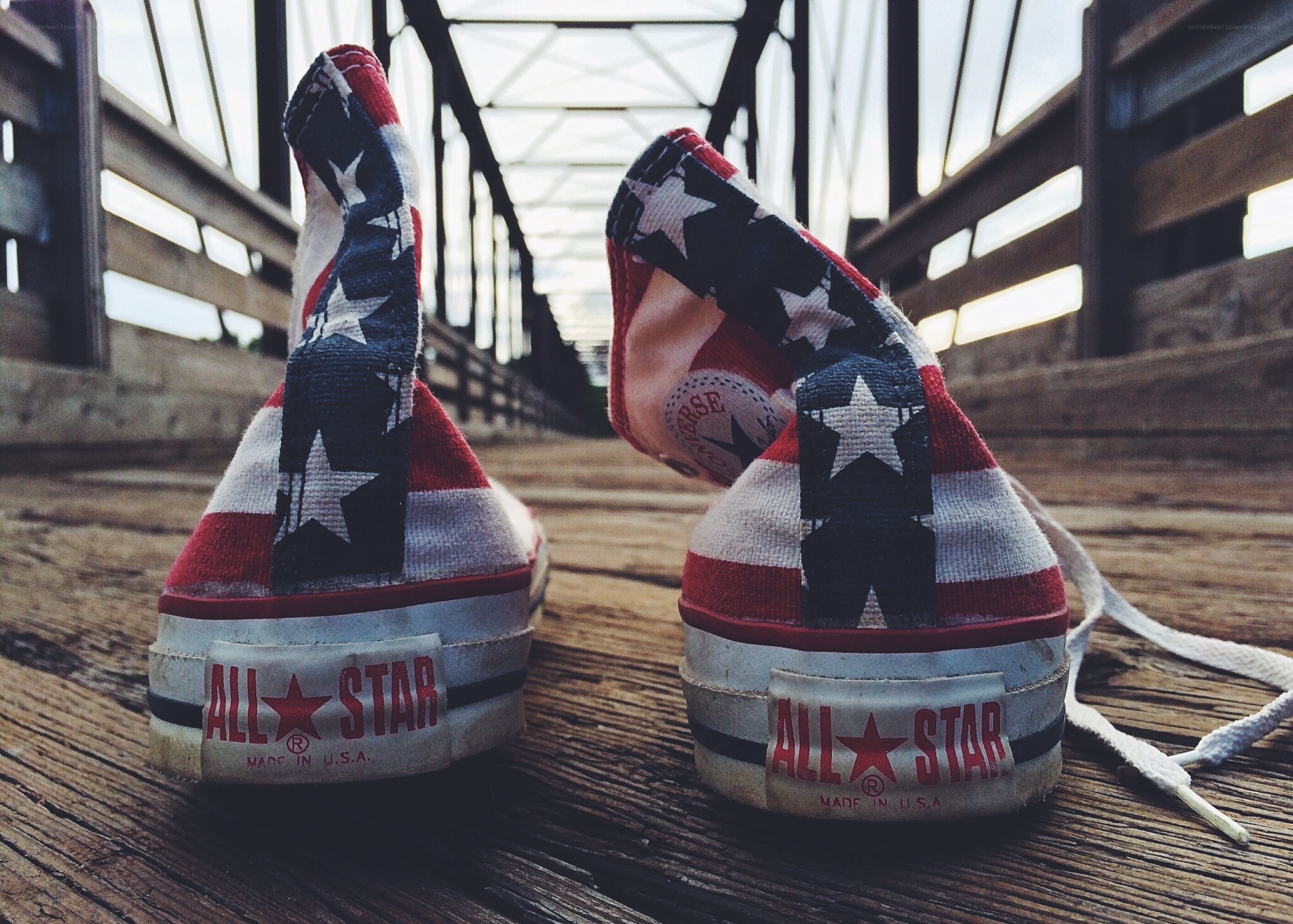 American flag sneakers on a bridge