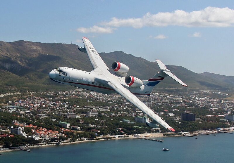 Amphibious aircraft flying over coastal city