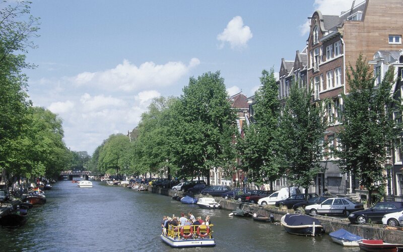 Amsterdam canal with tour boat