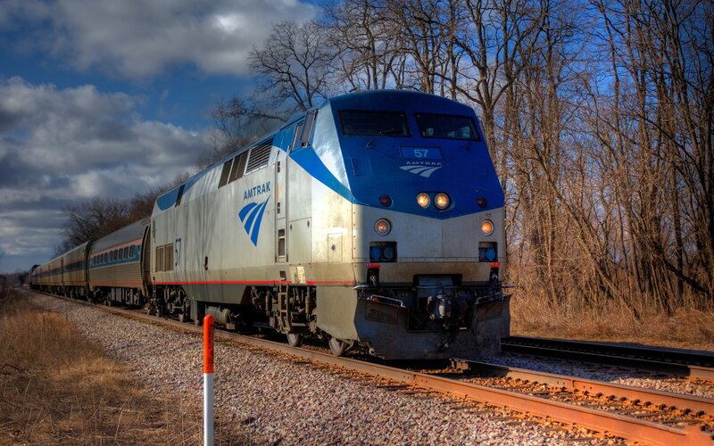 Amtrak Train on Tracks — Blue, Dramatic