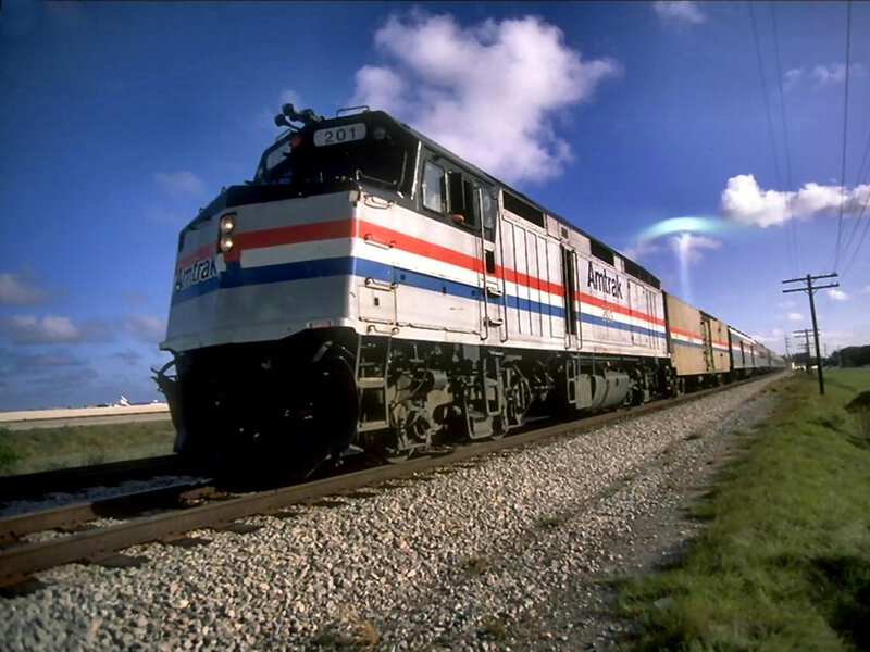 Amtrak Train on Tracks — Blue