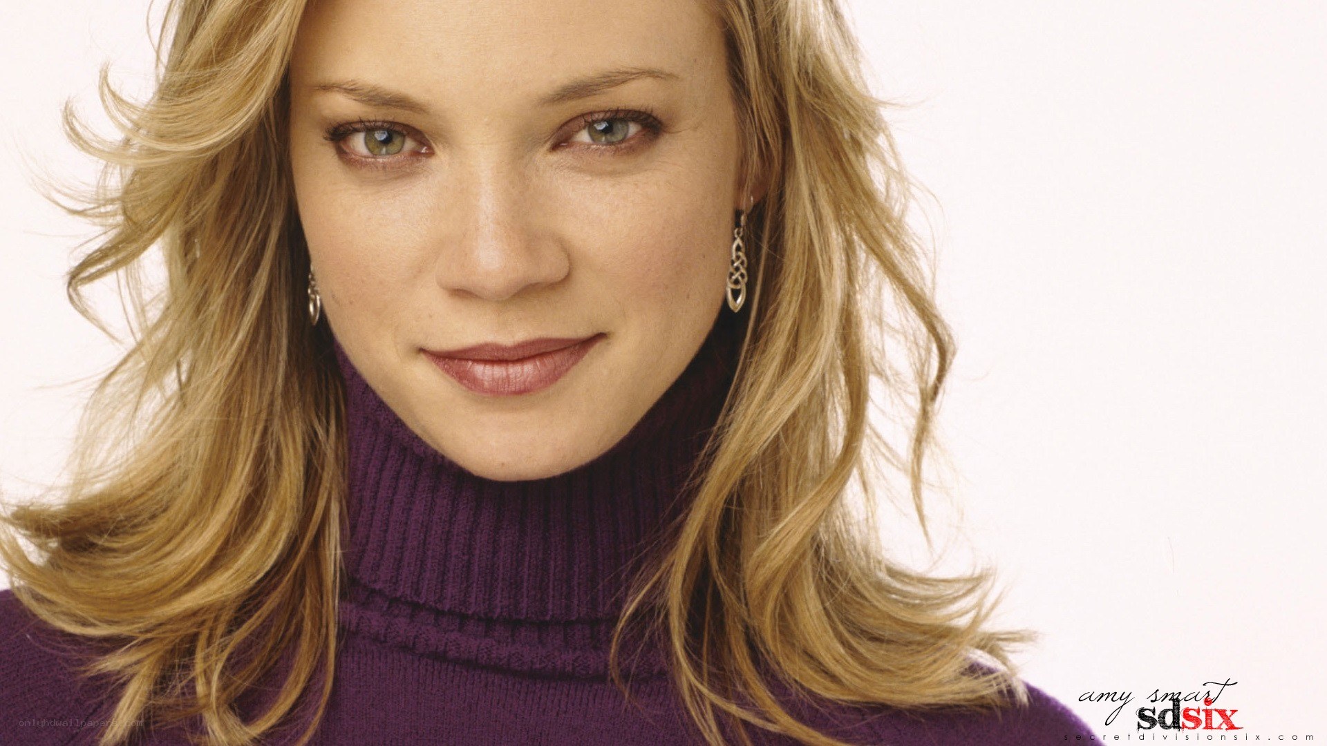 Amy Smart in purple turtleneck