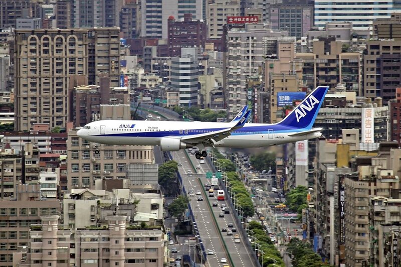 ANA Airplane over City
