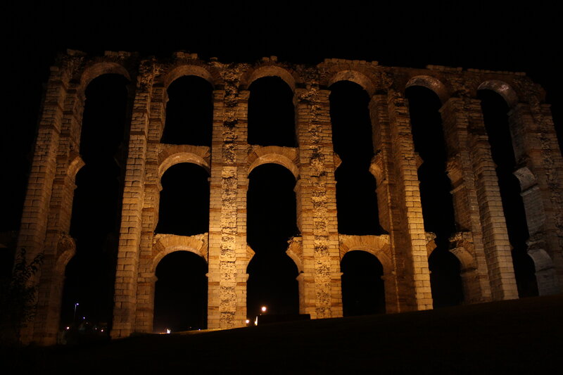 Ancient aqueduct at night