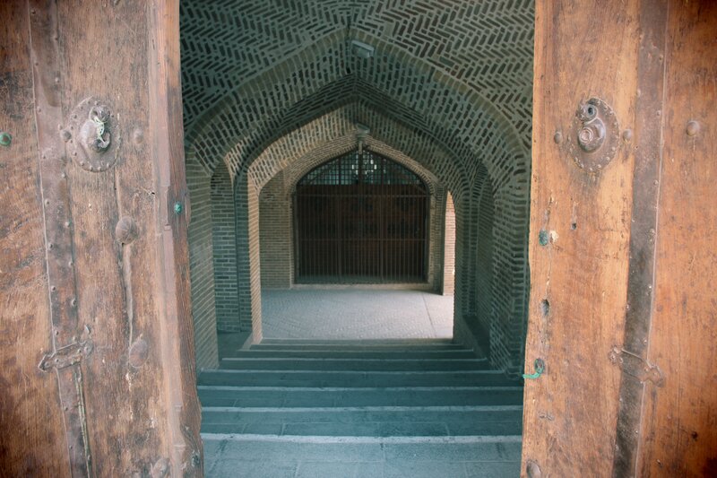 ancient brick corridor with wooden doors