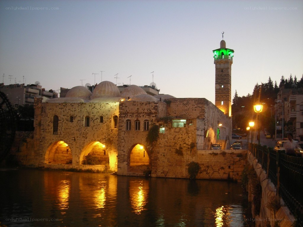 ancient bridge with mosque at dusk
