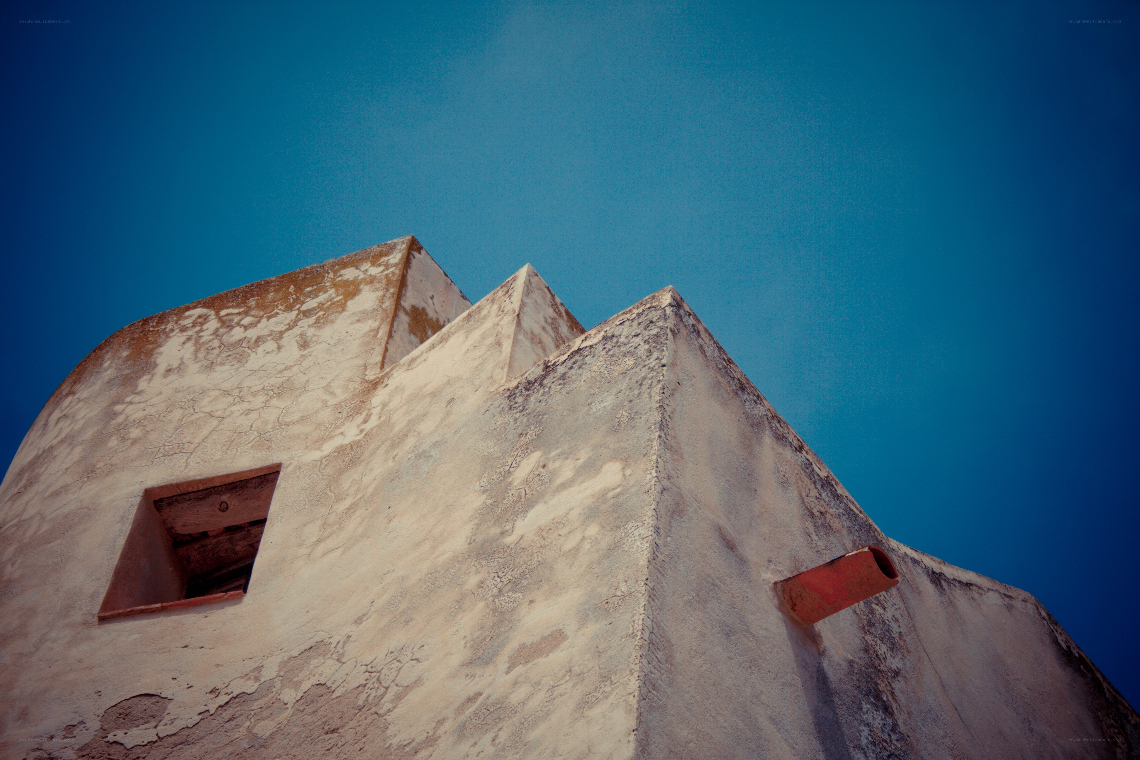 ancient building corner against blue sky