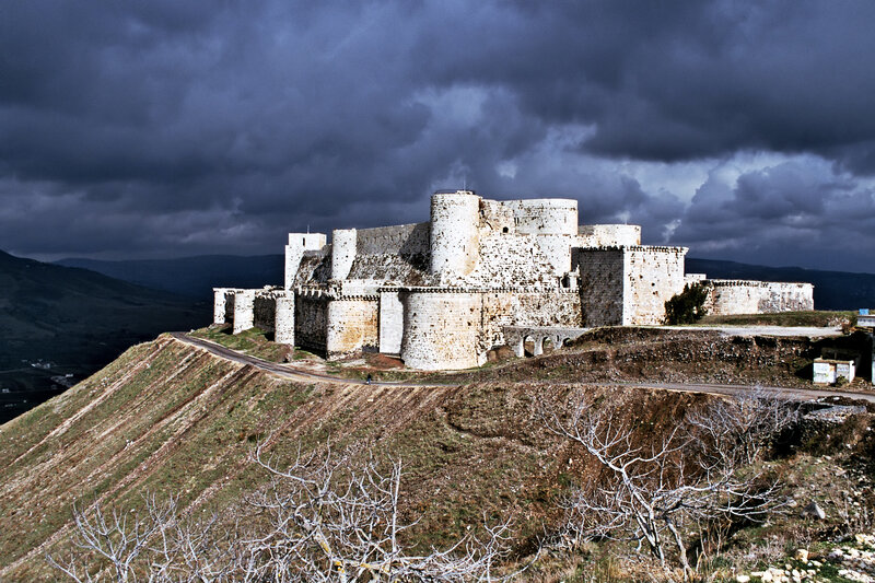 Ancient castle on a hill under stormy sky