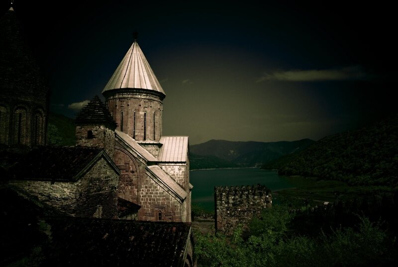 Ancient church by a lake at dusk