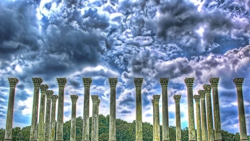 ancient columns under stormy sky