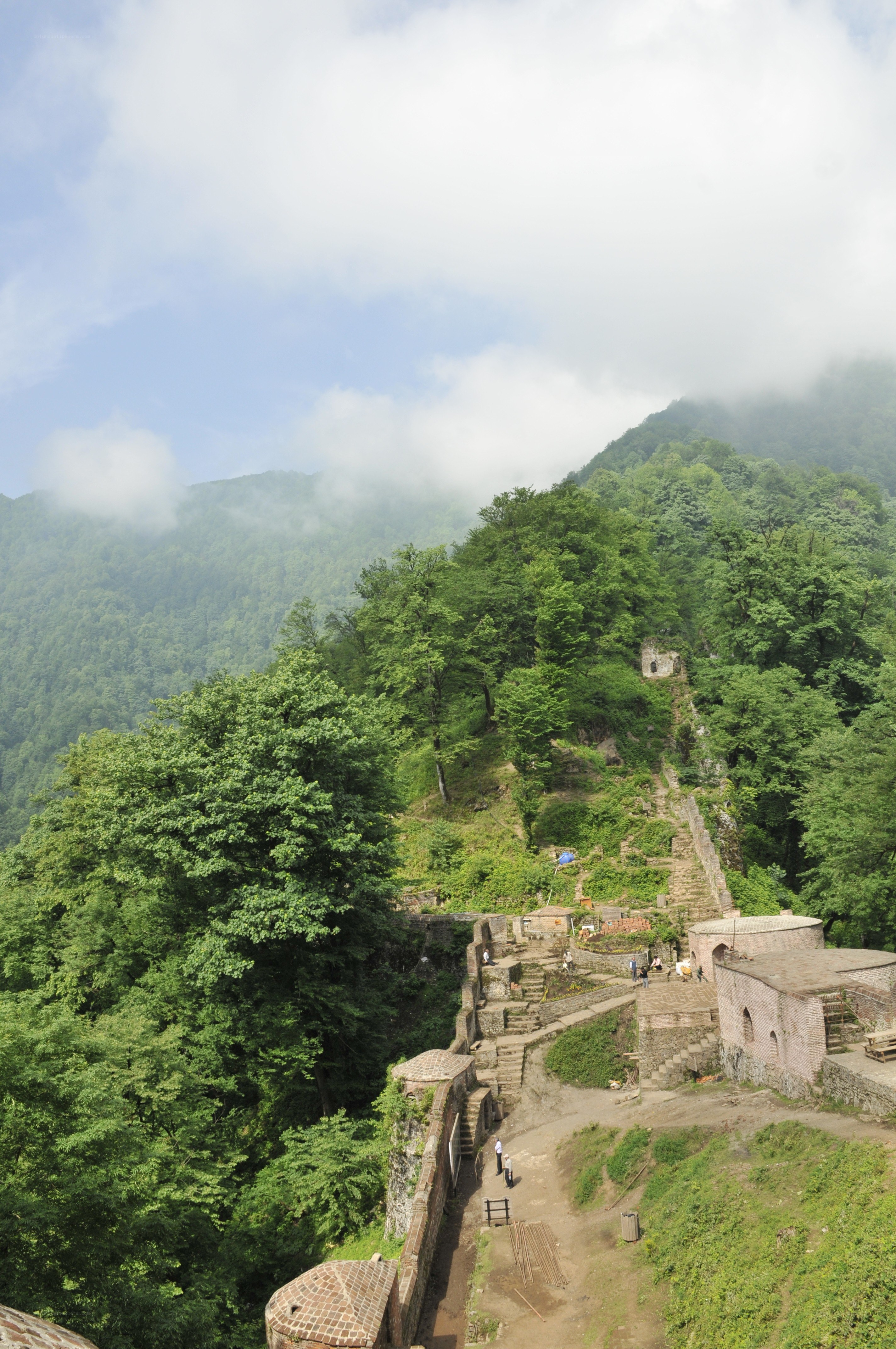 ancient fortress in forested mountains