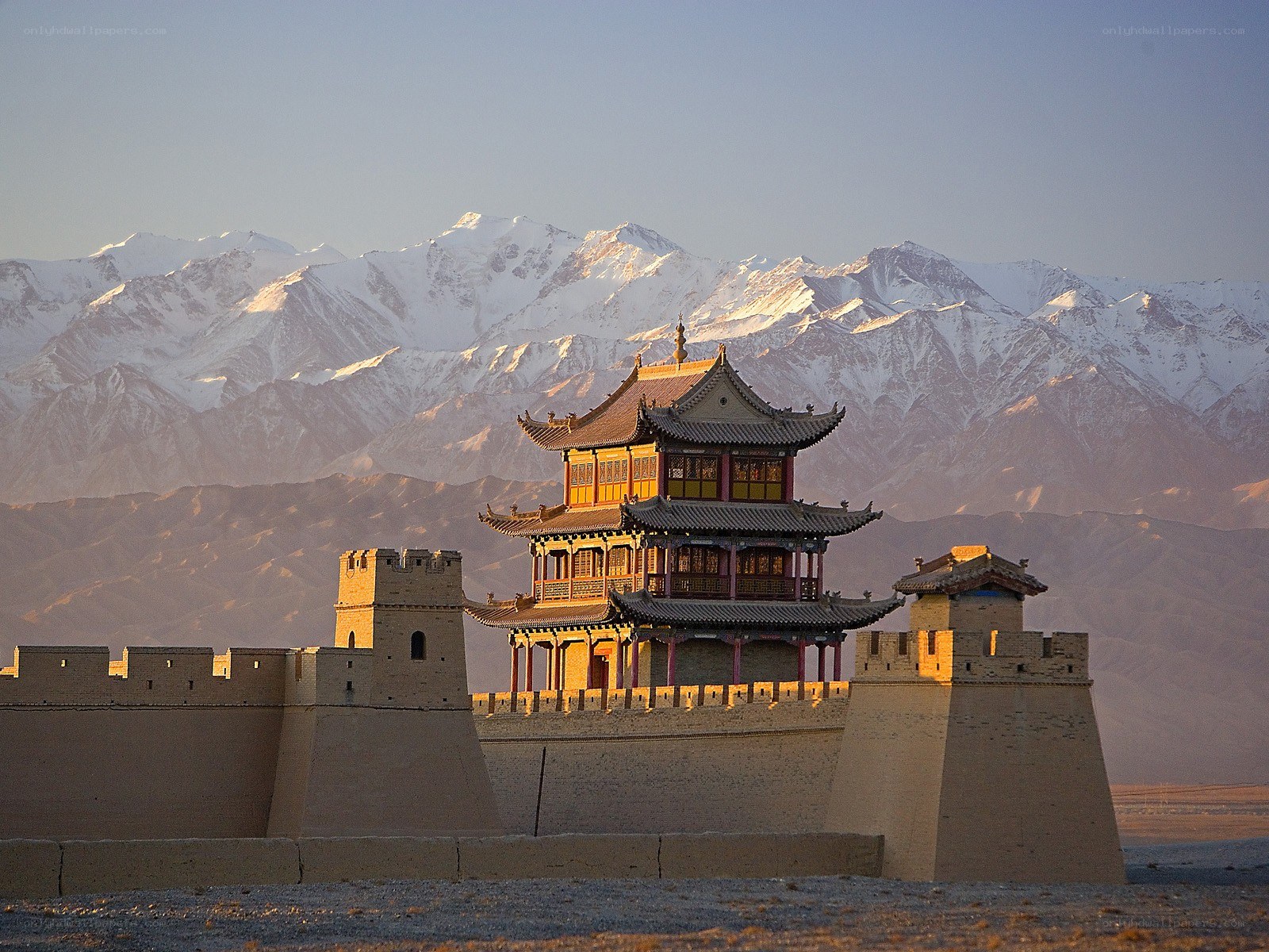 ancient fortress with snow-capped mountains