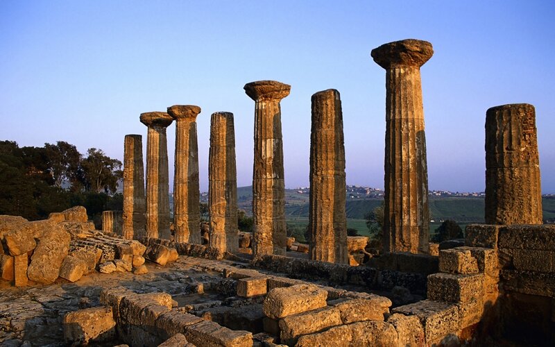 Ancient Greek columns at sunset