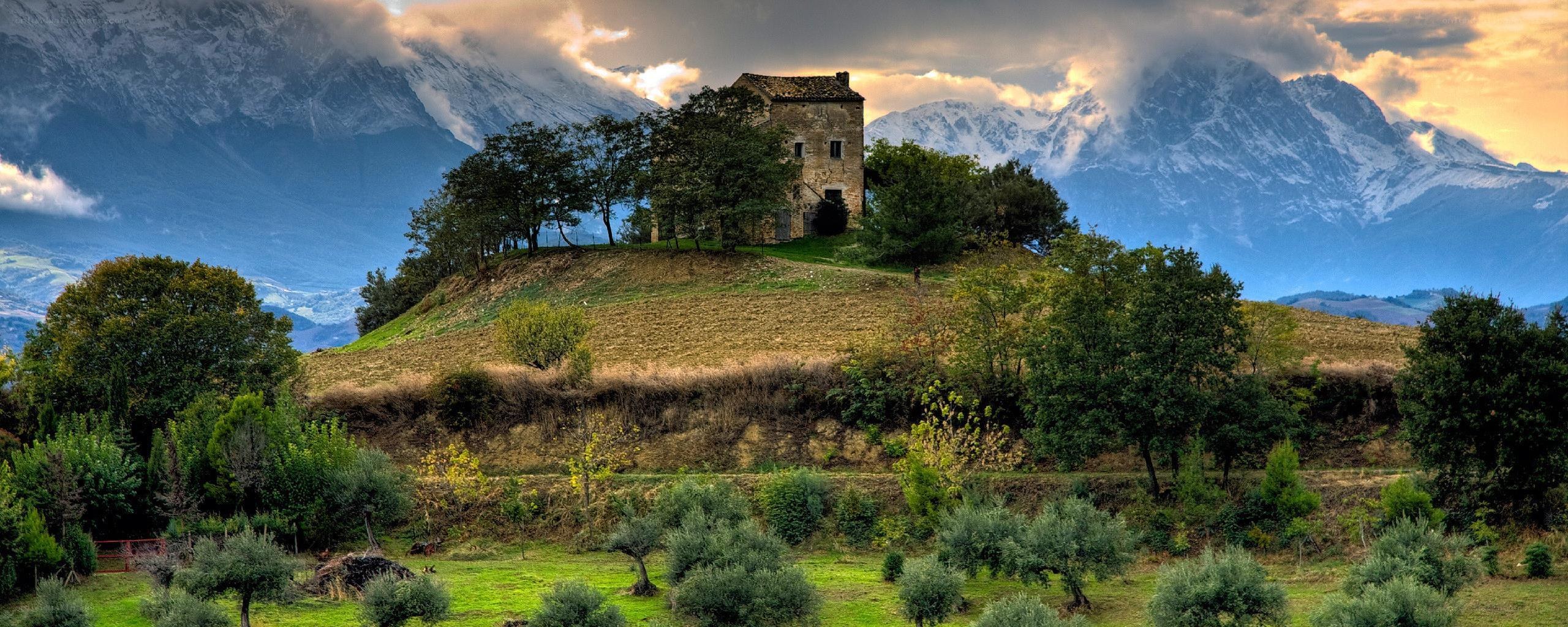 Ancient house on a hill with mountains