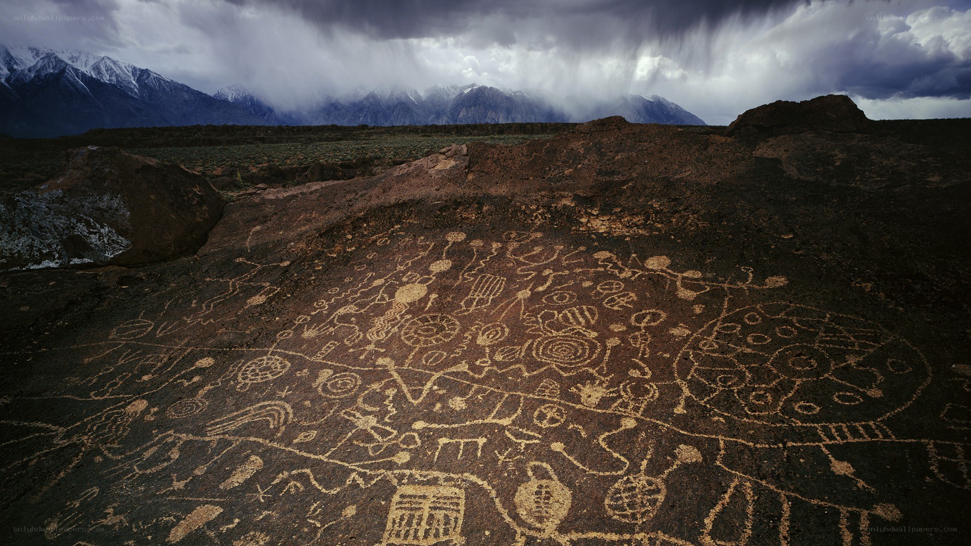 Ancient petroglyphs under stormy sky
