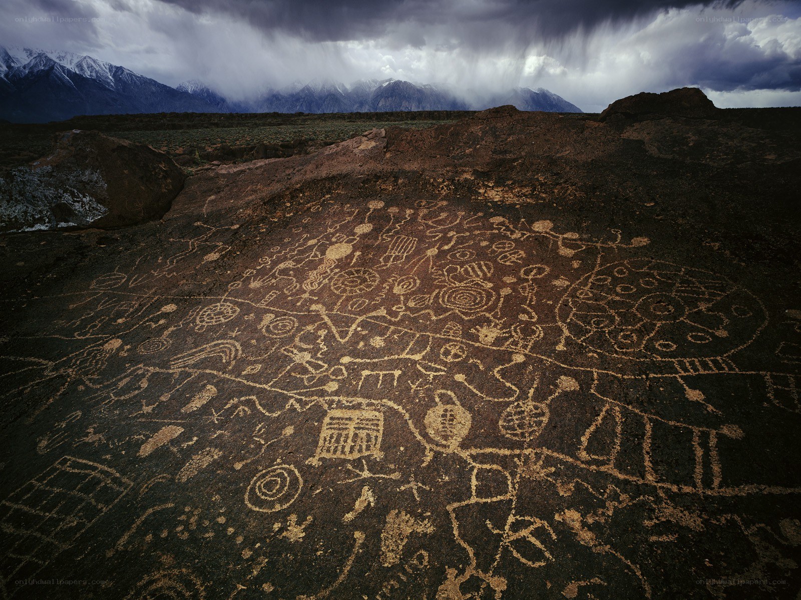 Ancient petroglyphs under stormy sky