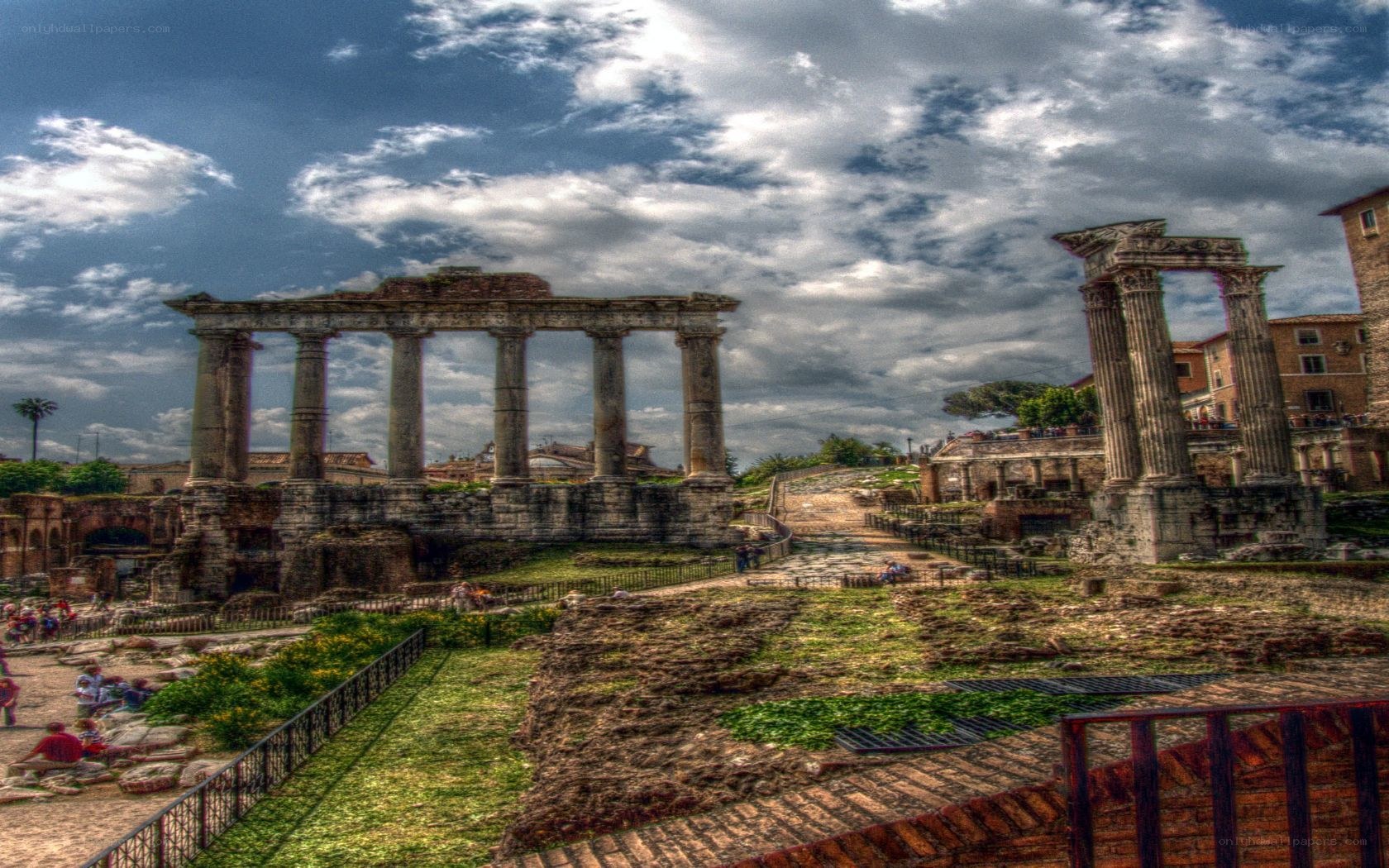 Ancient Roman ruins under cloudy sky